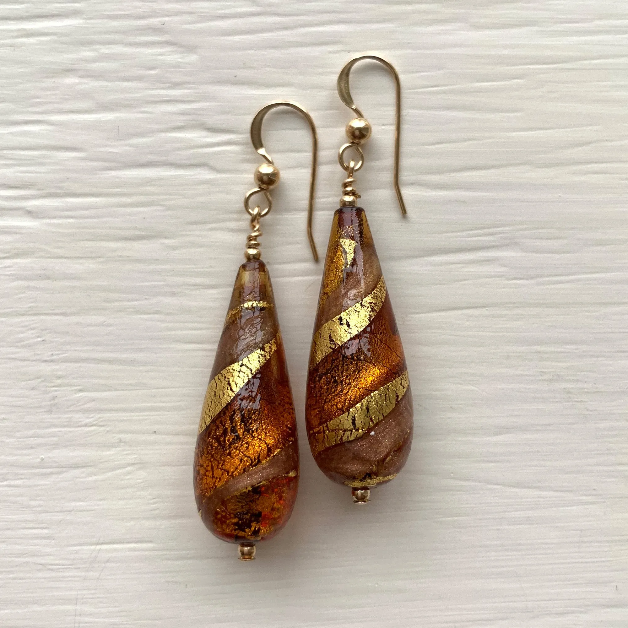 Earrings with brown topaz and aventurine swirl over gold Murano glass long pear drops